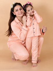 Mother and daughter wearing matching peach Shamoz silk pajamas