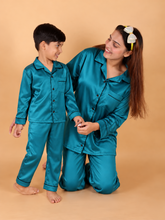 Mother and son wearing matching teal green Shamoz silk pajamas