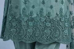Close-up of sea green embroidered shirt hem