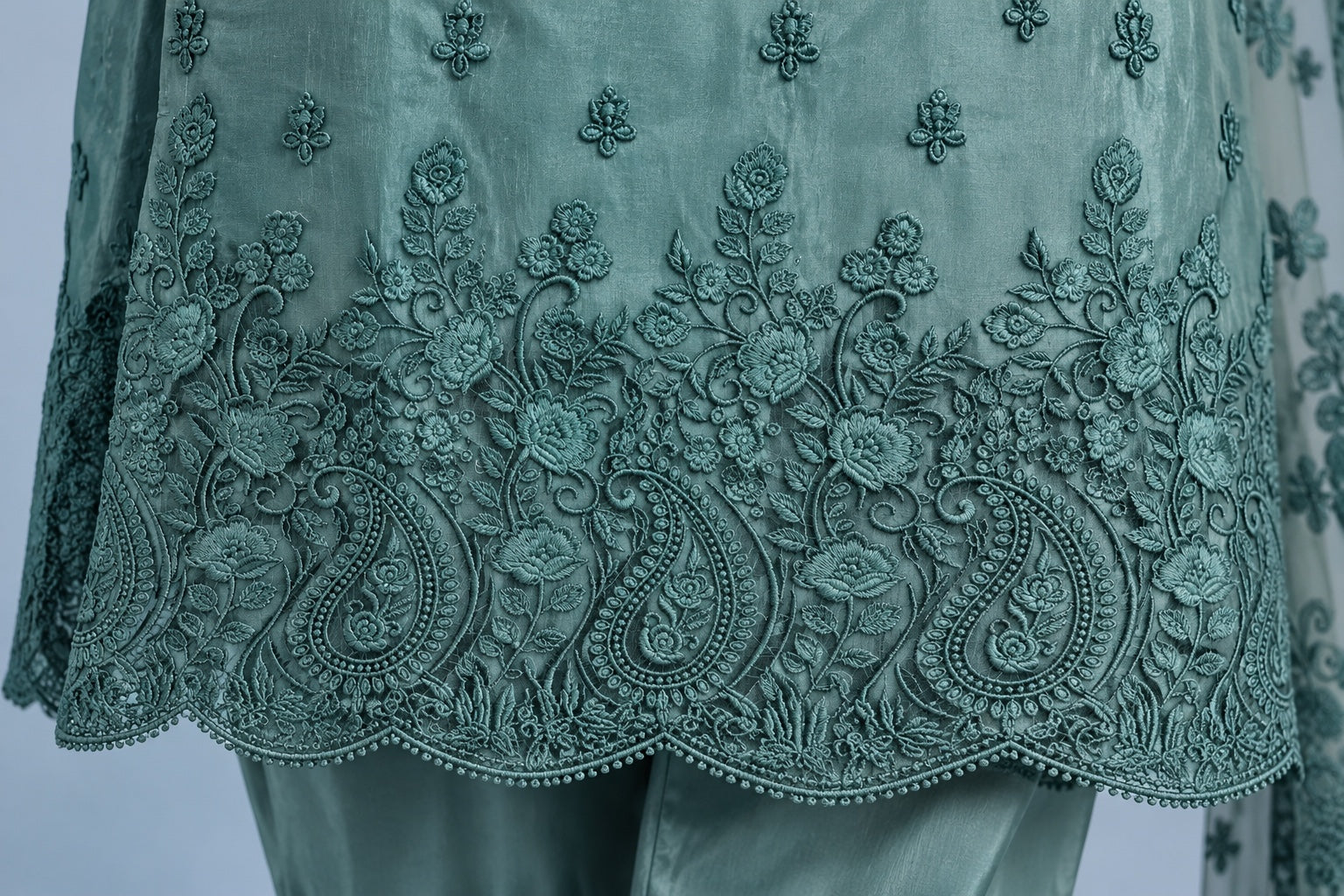 Close-up of sea green embroidered shirt hem
